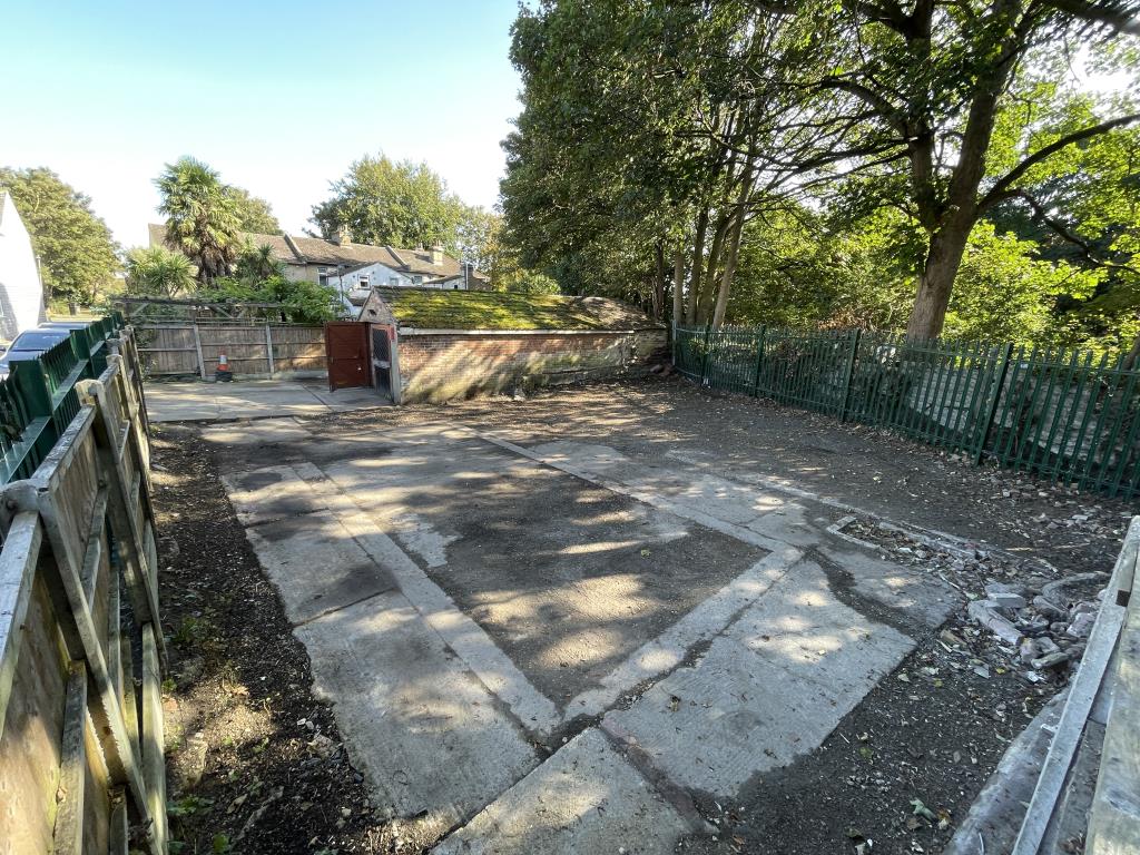 Lot: 53 - GATED STORAGE AND WORKSHOP YARD WITH POTENTIAL - View above side fence overlooking site